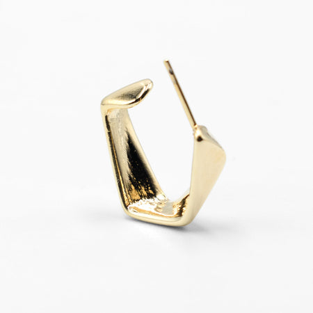 Gold hoop earring on a white background