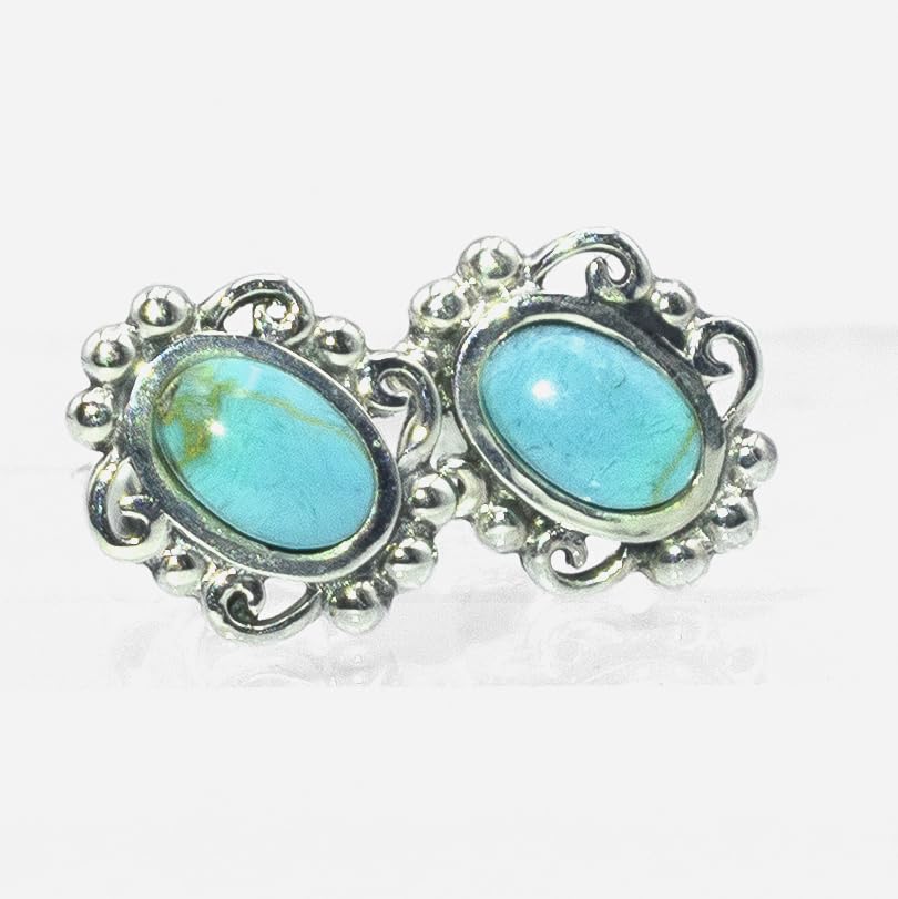 Pair of earrings with turquoise stones and silver frames on a white background